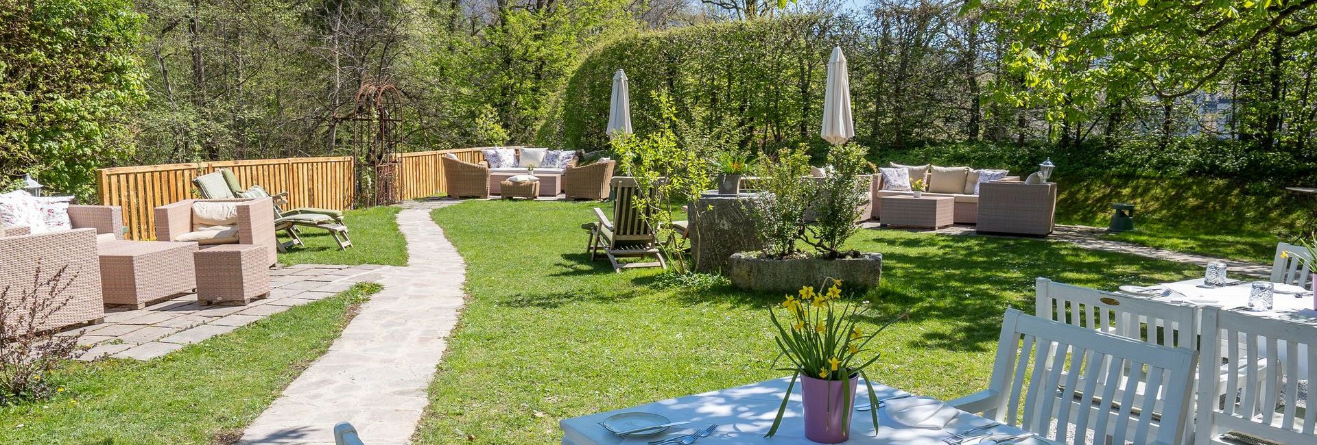 Garden with comfortable lounge chairs at Schlosswirt zu Anif near Salzburg