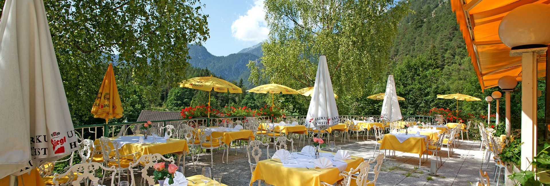 Sun terrace with set tables at Hotel Schloss Fernsteinsee in Tyrol