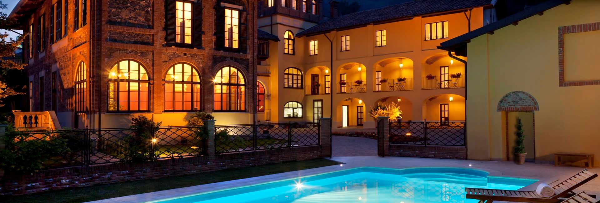 Villa Soleil by night with lightened windows and exterior pool